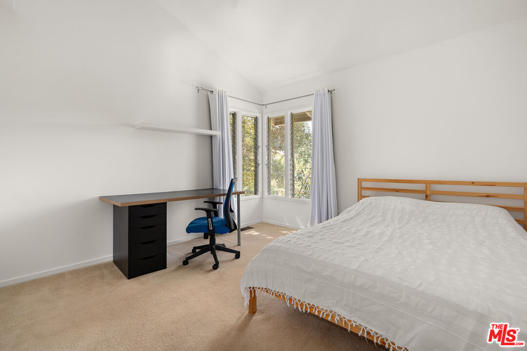 3775 Fredonia Drive Los Angeles, CA 90068 - Photo 15 of 16 a bedroom with a bed and a table