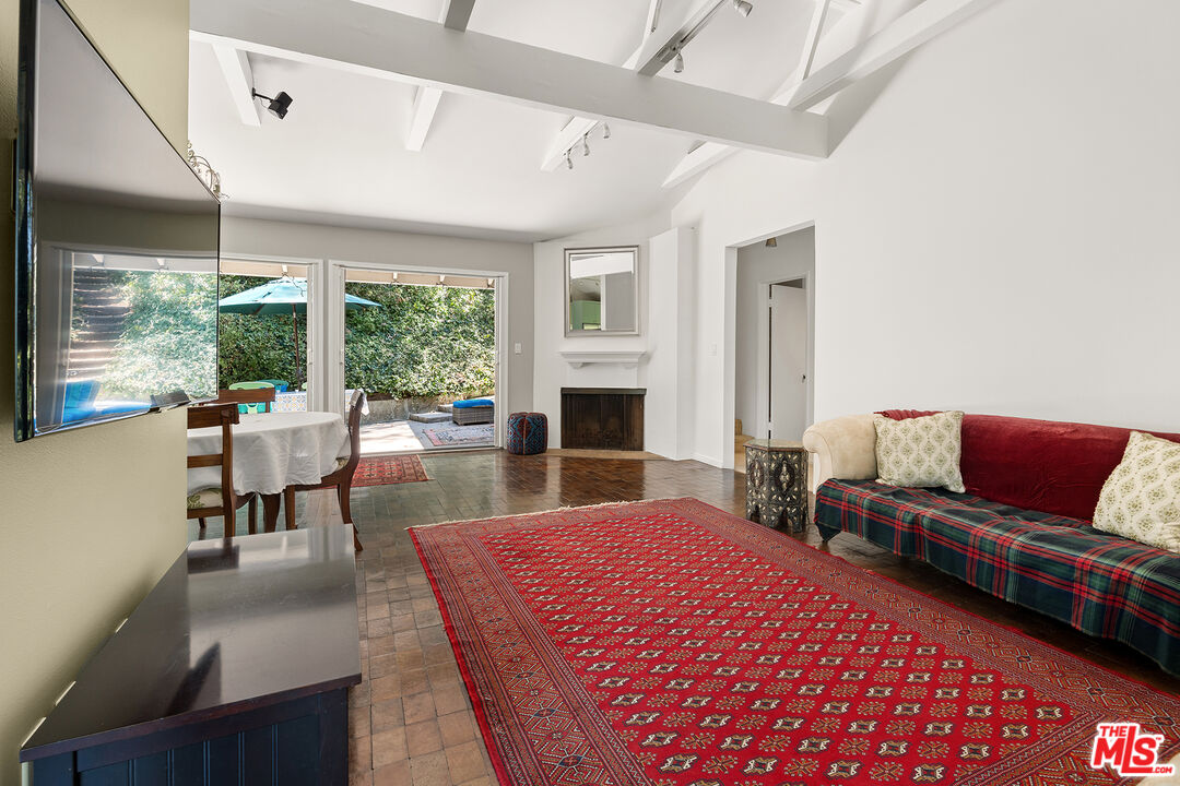 3775 Fredonia Drive Los Angeles, CA 90068 - Photo 5 of 16 a living room with furniture a large window and a fireplace