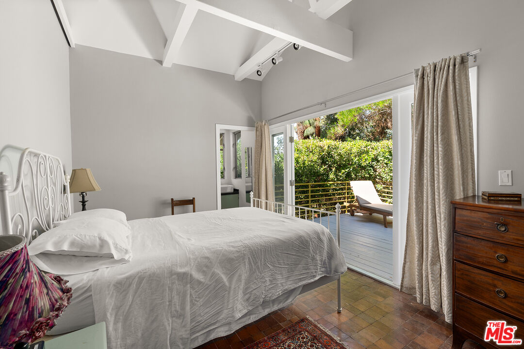 3775 Fredonia Drive Los Angeles, CA 90068 - Photo 9 of 16 a bedroom with a bed and large windows