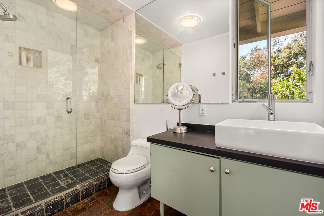 3775 Fredonia Drive Los Angeles, CA 90068 - Photo 10 of 16 a bathroom with a sink a toilet and shower