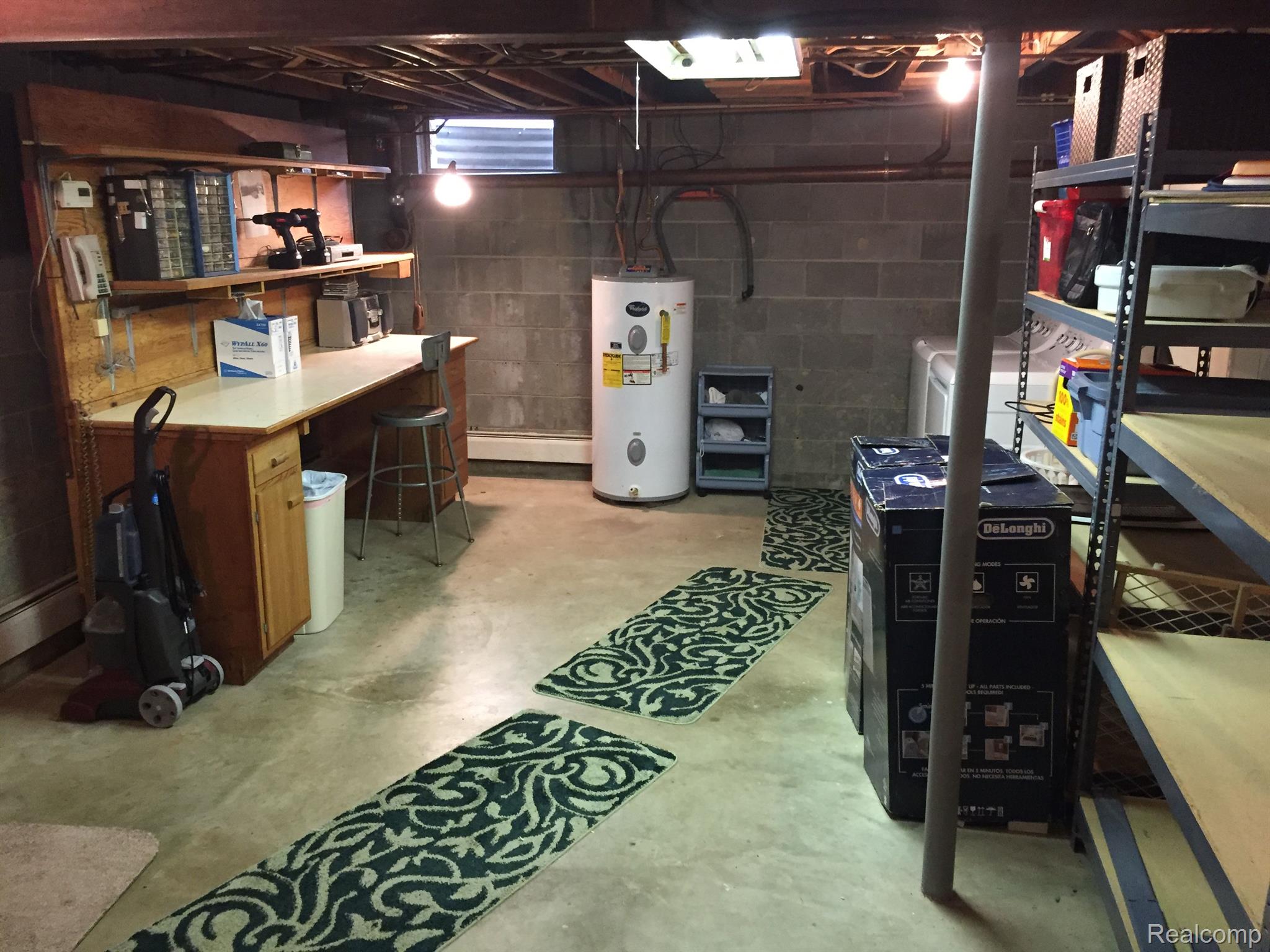 5657 Cribbins Road Avoca, MI 48006 - Photo 40 of 66 Work bench and hot water heater in basemetn