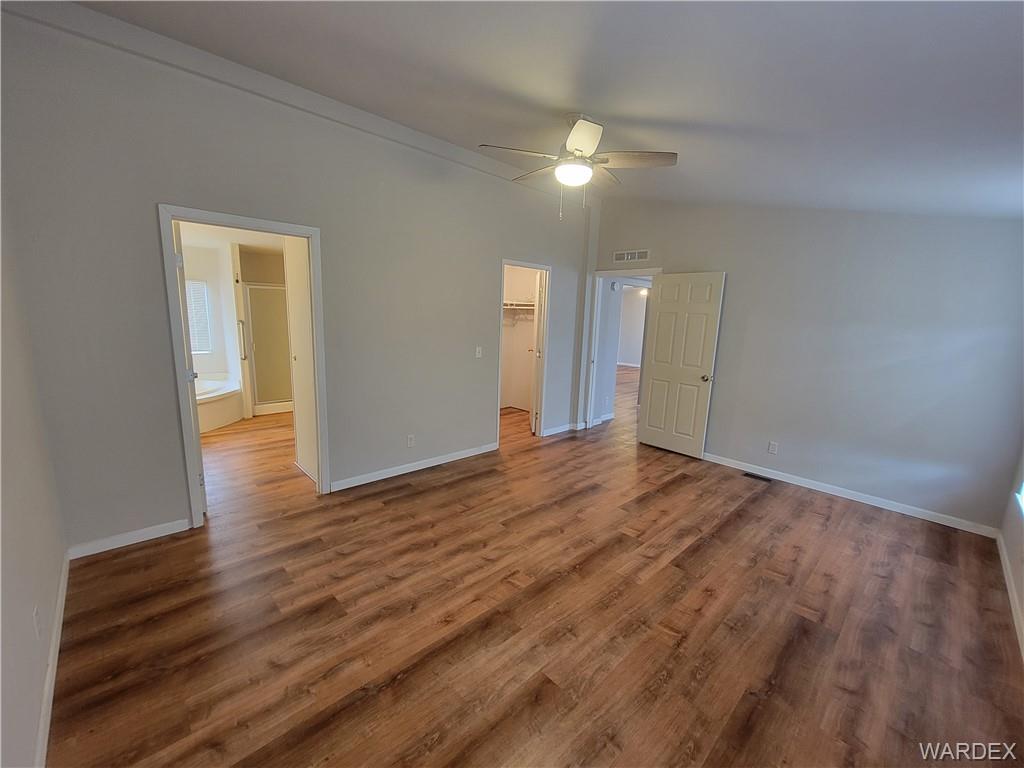 3469 Bouse Road Golden Valley, AZ 86413 - Photo 20 of 37 a view of a big room with wooden floor and windows