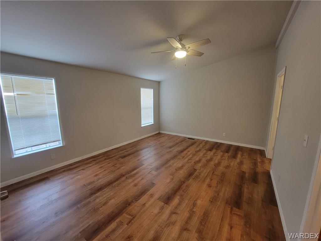 3469 Bouse Road Golden Valley, AZ 86413 - Photo 21 of 37 a view of an empty room with wooden floor and a window