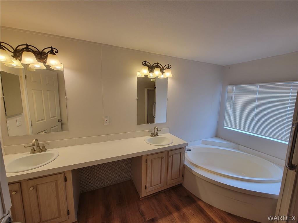3469 Bouse Road Golden Valley, AZ 86413 - Photo 24 of 37 a bathroom with a tub sink and mirror