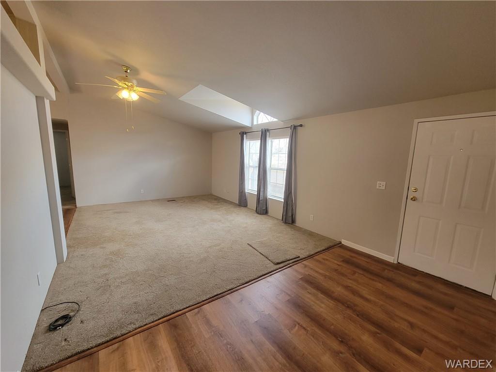 3469 Bouse Road Golden Valley, AZ 86413 - Photo 9 of 37 an empty room with wooden floor and windows