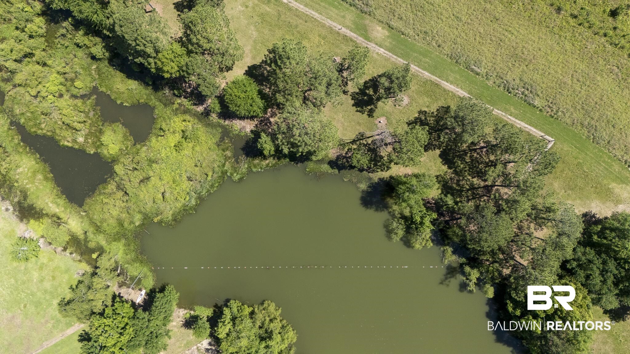30580 County Road 49 Loxley, AL 36551 - Photo 15 of 32 Aerial perspective showcasing a substantial body of water, bordered by verdant landscapes