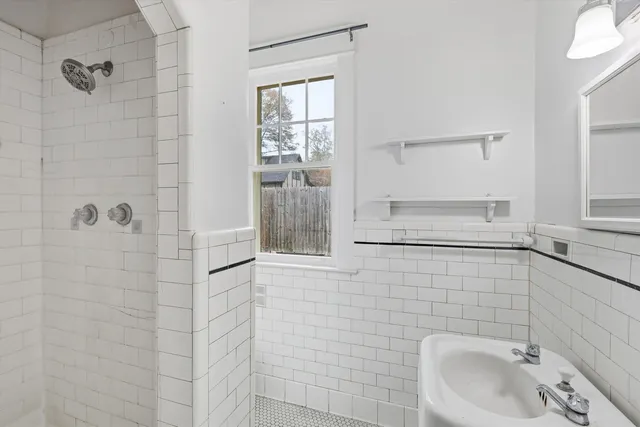 a bathroom with a sink and shower