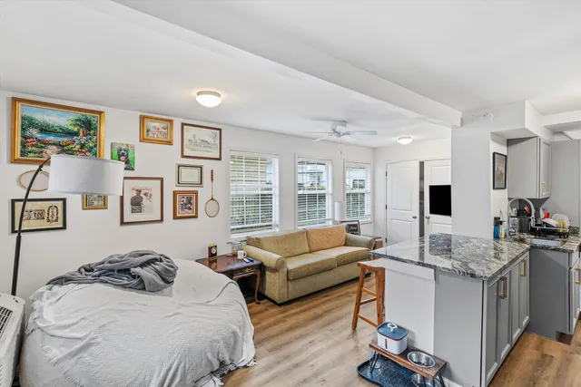 a bedroom with a bed couch and a window