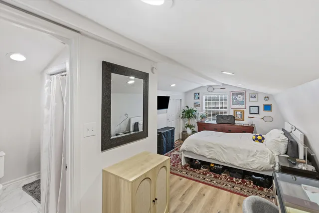 a bedroom with furniture and a book shelf