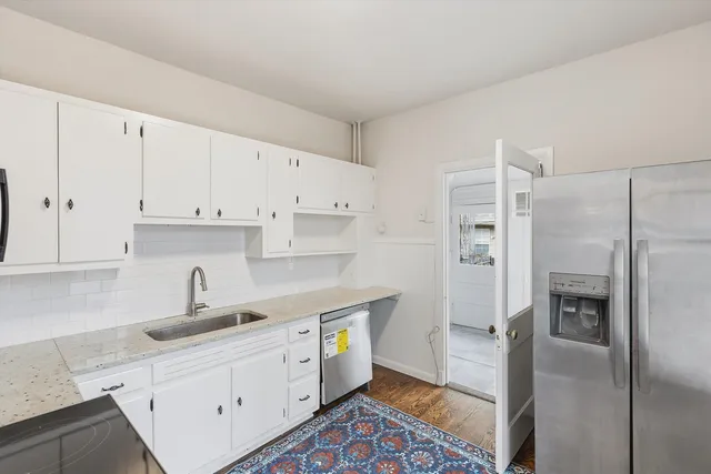 a kitchen with cabinets and stainless steel appliances