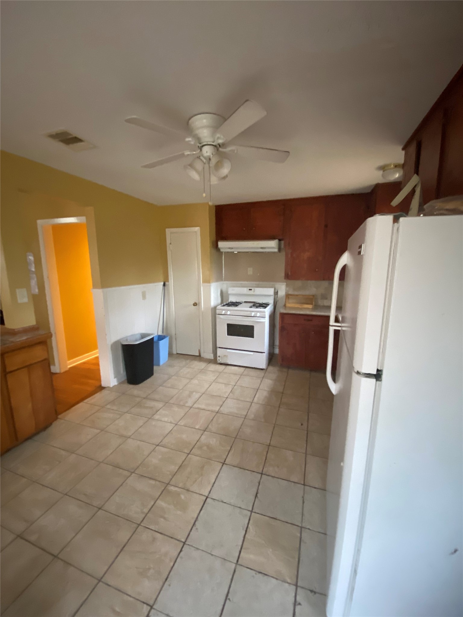 2504 Pennington Street Houston, TX 77093 - Photo 2 of 9 a kitchen with a refrigerator and a stove top oven