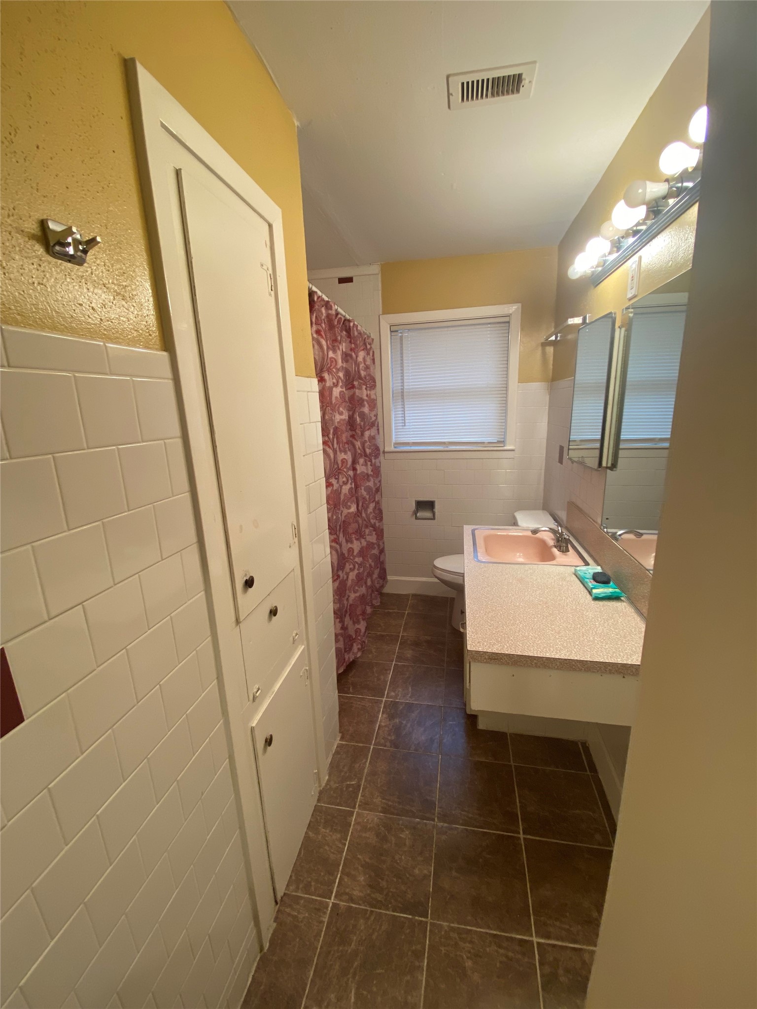 2504 Pennington Street Houston, TX 77093 - Photo 7 of 9 a bathroom with a sink a mirror and a shower