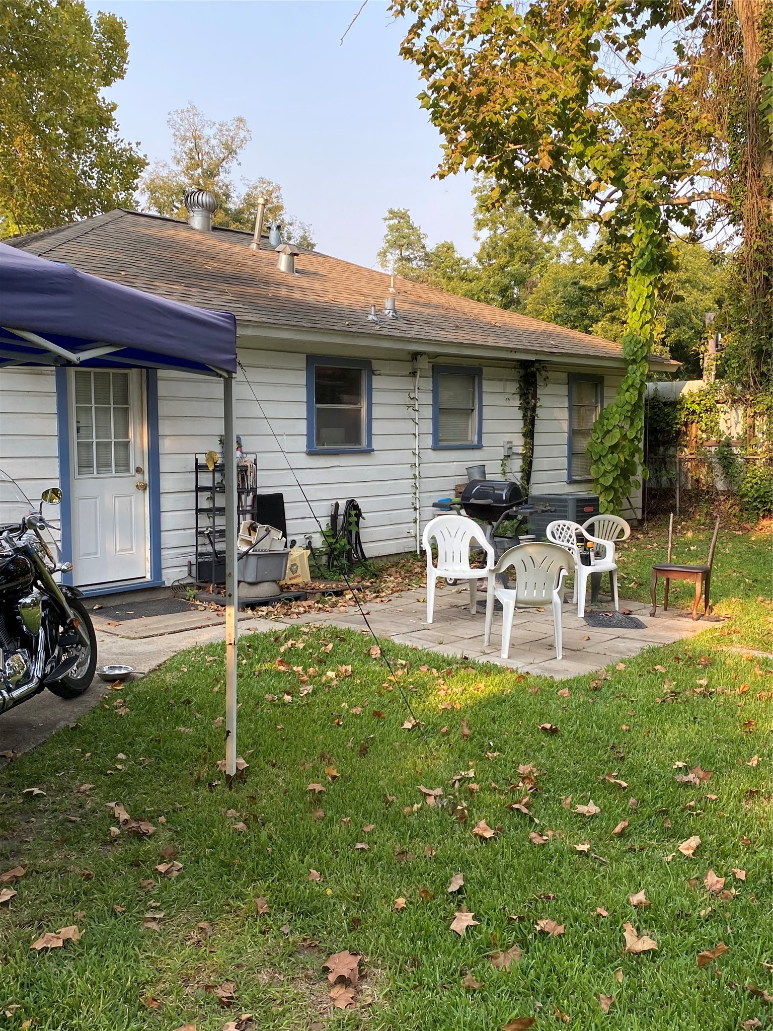 2504 Pennington Street Houston, TX 77093 - Photo 8 of 9 a white house with lawn chairs and a small yard