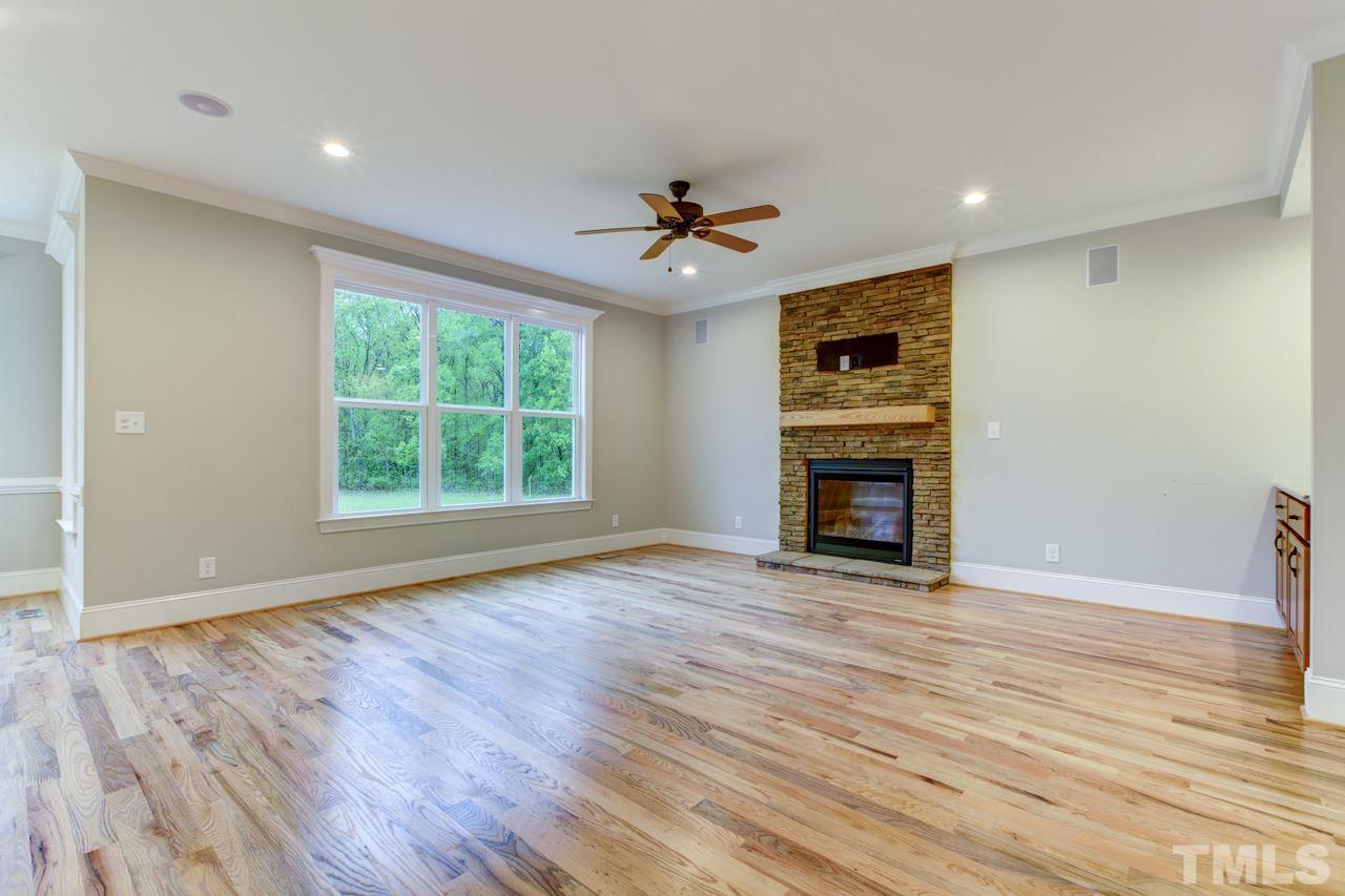 5509 Red Line Court Raleigh, NC 27603 - Photo 22 of 23 an empty room with wooden floor ceiling fan and windows