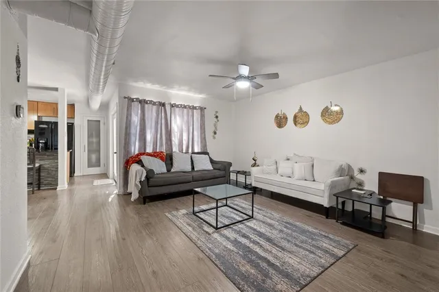 a living room with furniture and wooden floor