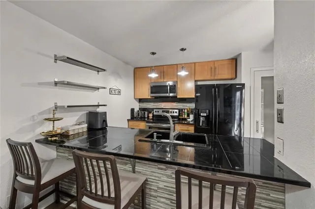 a kitchen with stainless steel appliances a microwave a stove and white cabinets