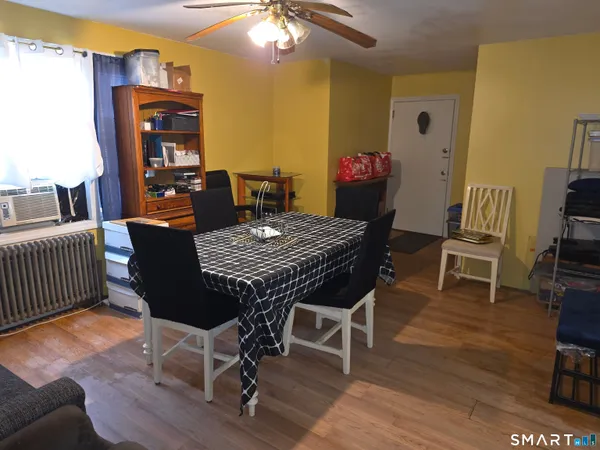 a view of a dining room with furniture and wooden floor