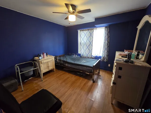 a living room with furniture a flat screen tv and a window