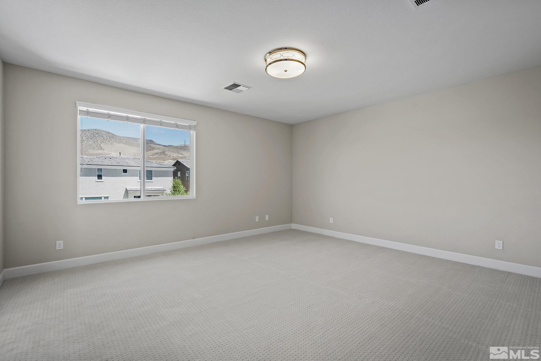 2995 Bonfire Lane Reno, NV 89521 - Photo 18 of 40 an empty room with windows and refrigerator