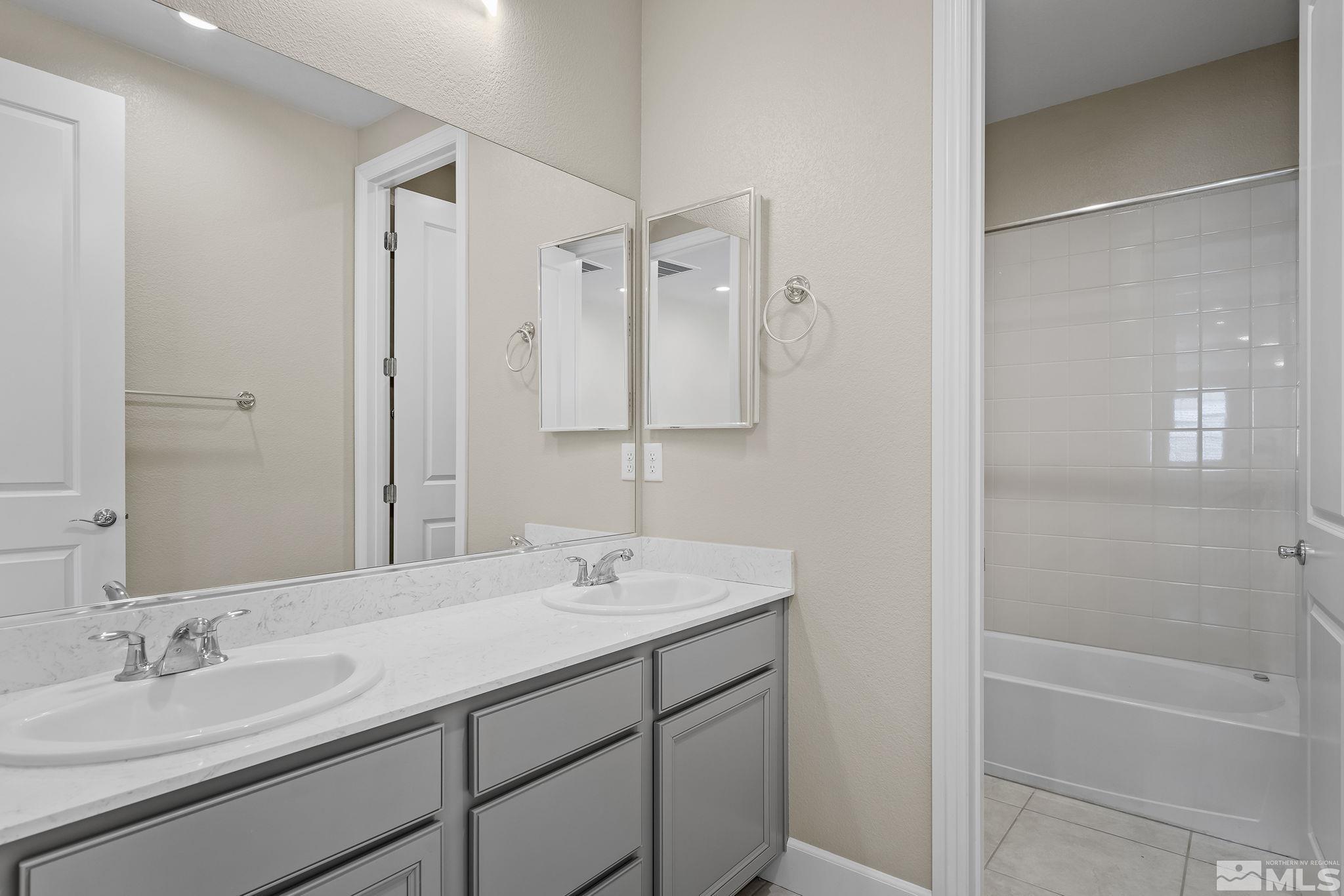 2995 Bonfire Lane Reno, NV 89521 - Photo 23 of 40 a bathroom with a double vanity sink mirror double and bathtub