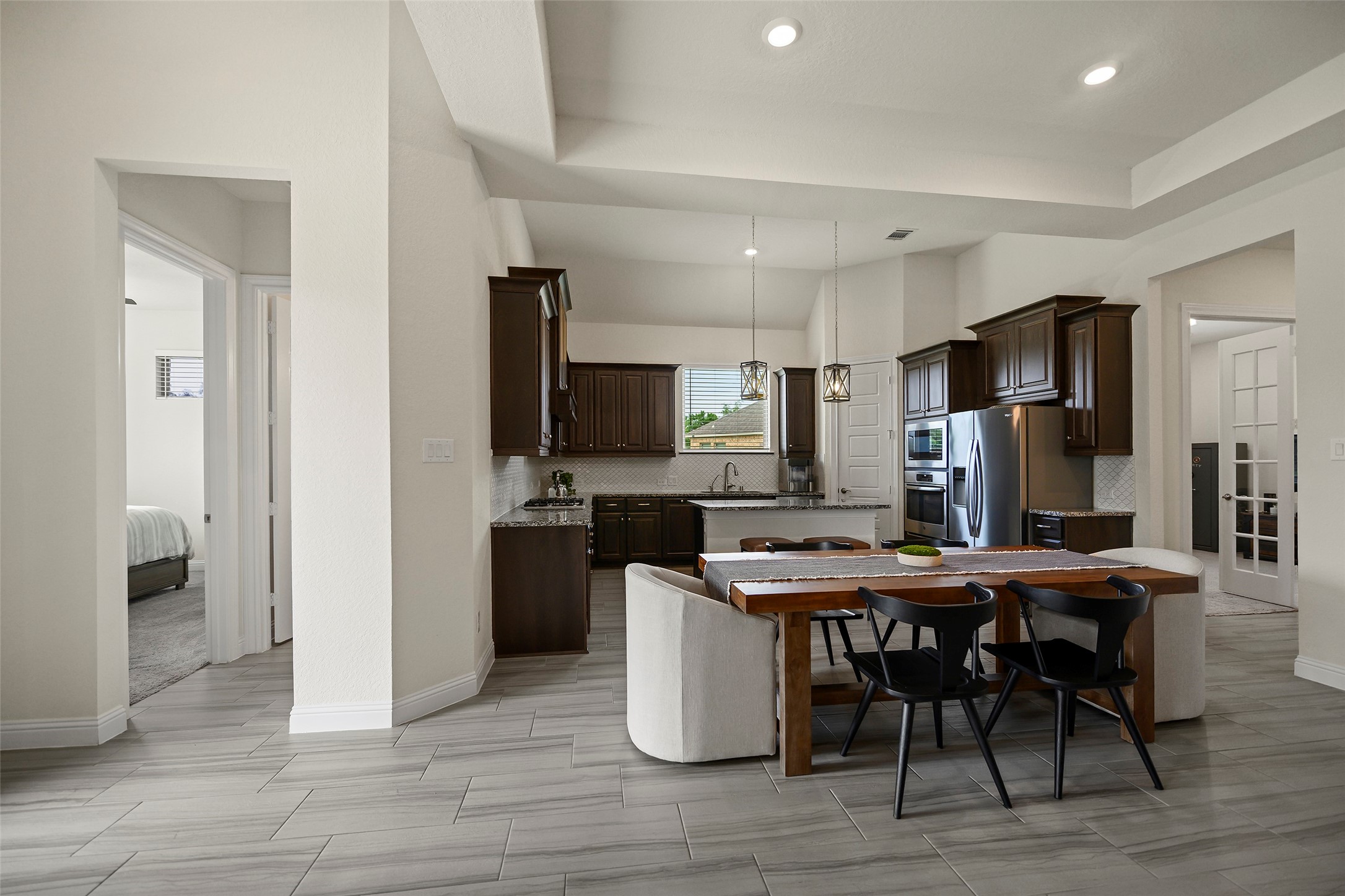 20330 Rosegold Way Spring, TX 77379 - Photo 38 of 48 Open-concept layout offers exceptional flow between the kitchen, dining, and family room.