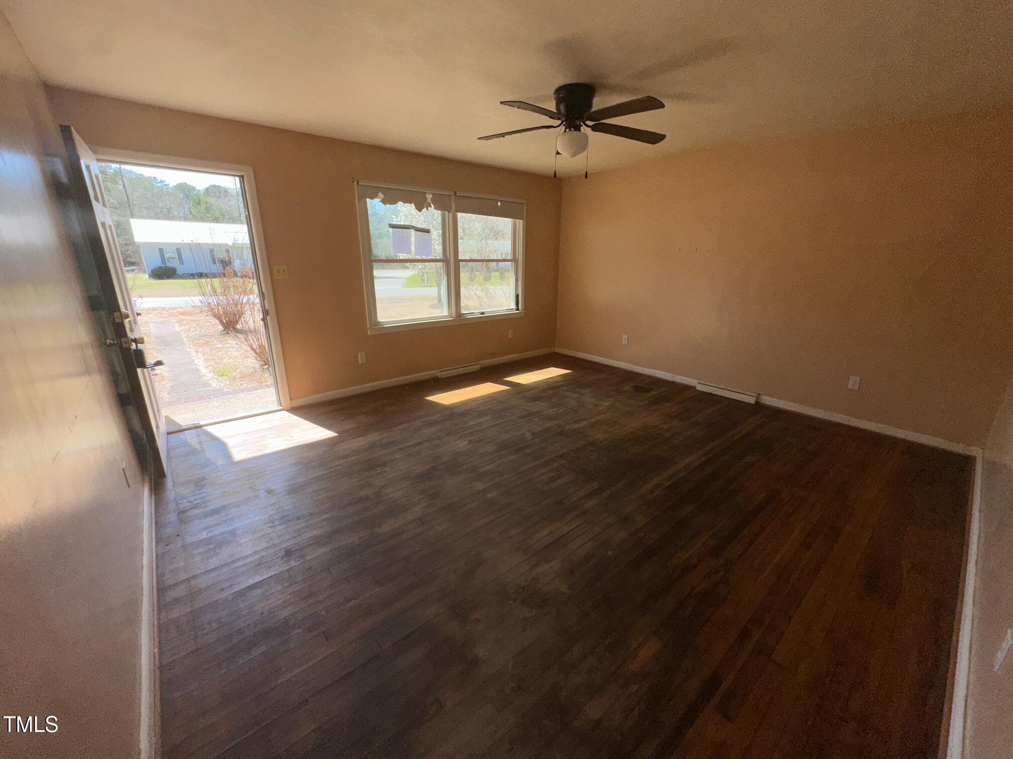 241 Cooke Circle Rich Square, NC 27869 - Photo 4 of 10 a view of empty room with wooden floor and fan