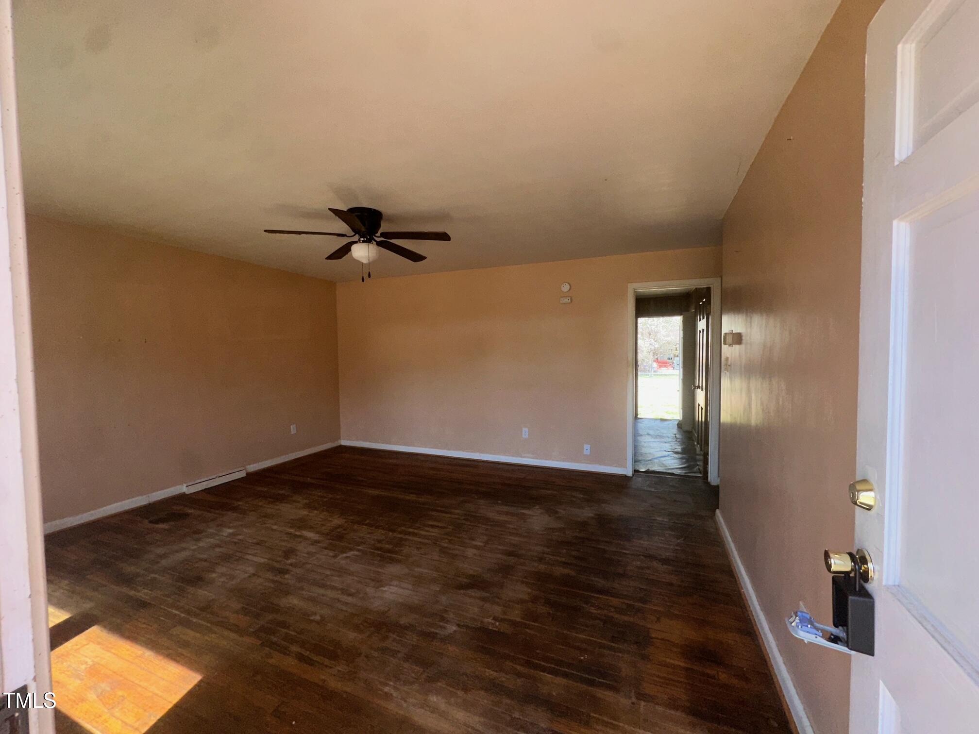 241 Cooke Circle Rich Square, NC 27869 - Photo 5 of 10 a view of a room with wooden floor and a ceiling fan