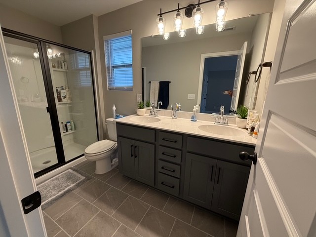 1737 Fenway Loop Antioch, TN 37013 - Photo 24 of 33 a bathroom with a double vanity sink toilet mirror and shower