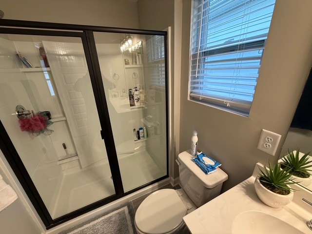 1737 Fenway Loop Antioch, TN 37013 - Photo 25 of 33 a white toilet sitting next to a bathroom sink and a mirror