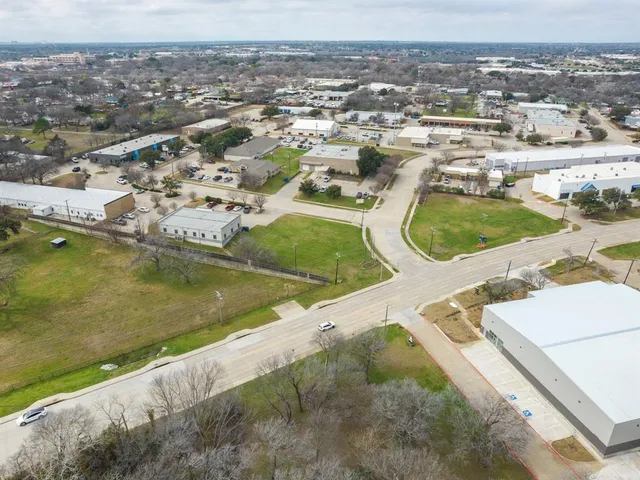 an aerial view of residential houses with outdoor space and river