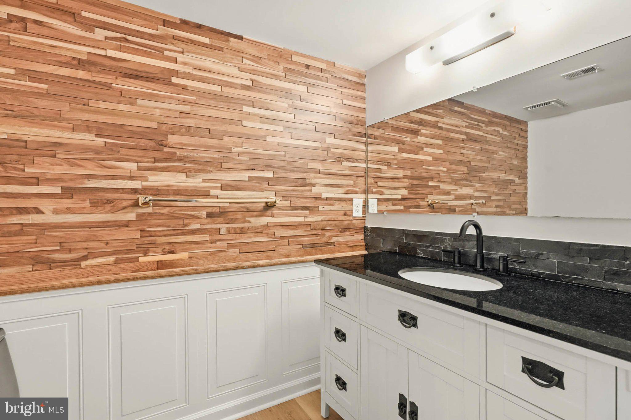 10901 Trotting Ridge Way, Unit 92 Columbia, MD 21044 - Photo 20 of 37 Sleek bathroom with warm wood accents.