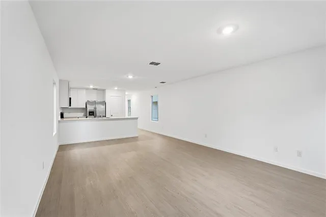 a kitchen with sink a microwave and cabinets