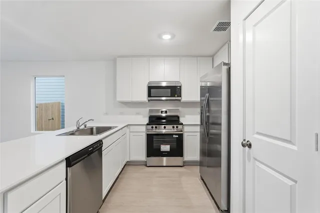 a kitchen with a stove and a microwave