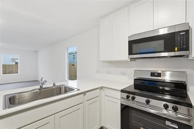 a kitchen with a stove and a microwave