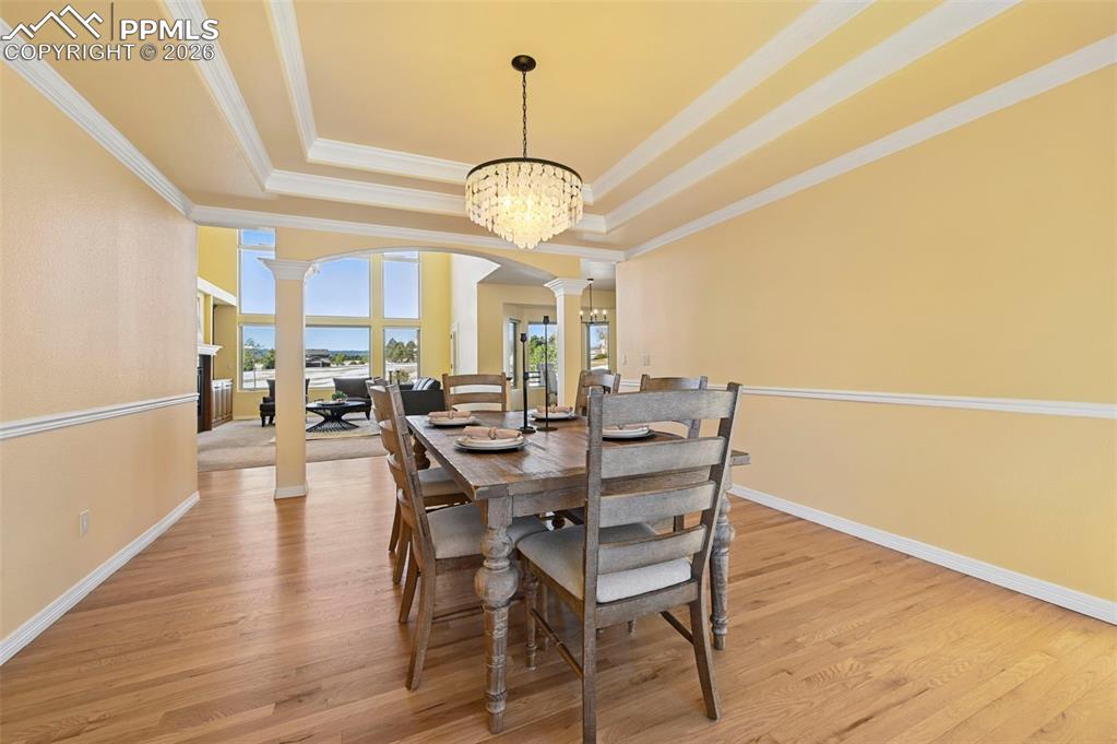19610 Rathbone Circle Monument, CO 80132 - Photo 13 of 41 a view of a dining room with furniture wooden floor and chandelier