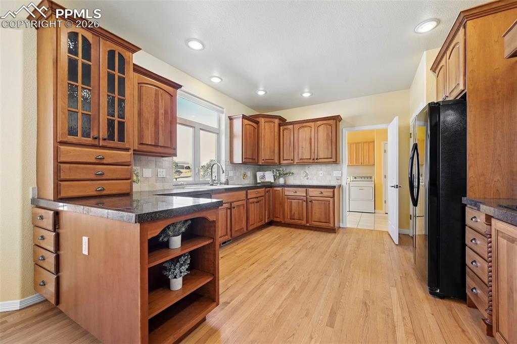 19610 Rathbone Circle Monument, CO 80132 - Photo 14 of 41 a kitchen with stainless steel appliances granite countertop a refrigerator a stove and a wooden floors