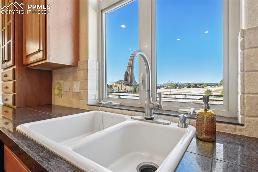 19610 Rathbone Circle Monument, CO 80132 - Photo 16 of 41 a bathroom with a tub a sink and a large window