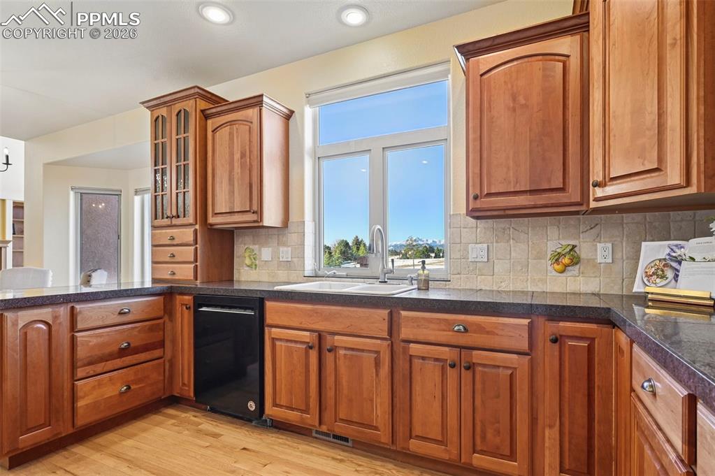 19610 Rathbone Circle Monument, CO 80132 - Photo 18 of 41 a kitchen with granite countertop wooden cabinets stainless steel appliances a sink and a window