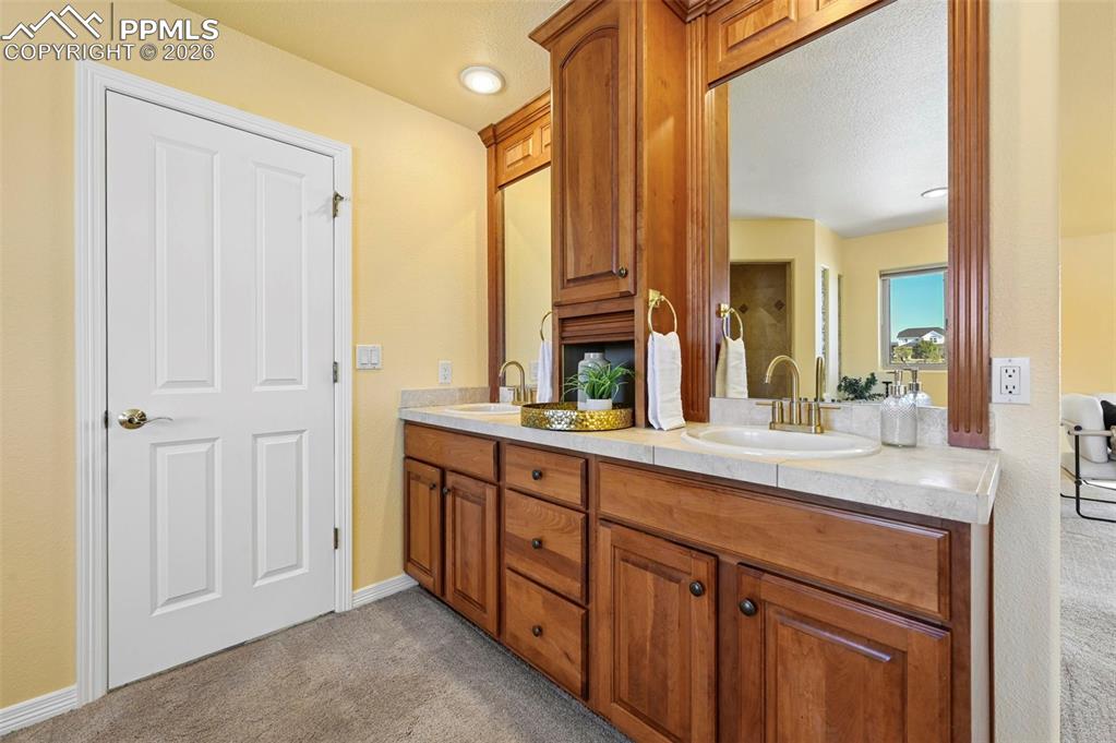 19610 Rathbone Circle Monument, CO 80132 - Photo 23 of 41 a spacious bathroom with a double vanity sink and a mirror