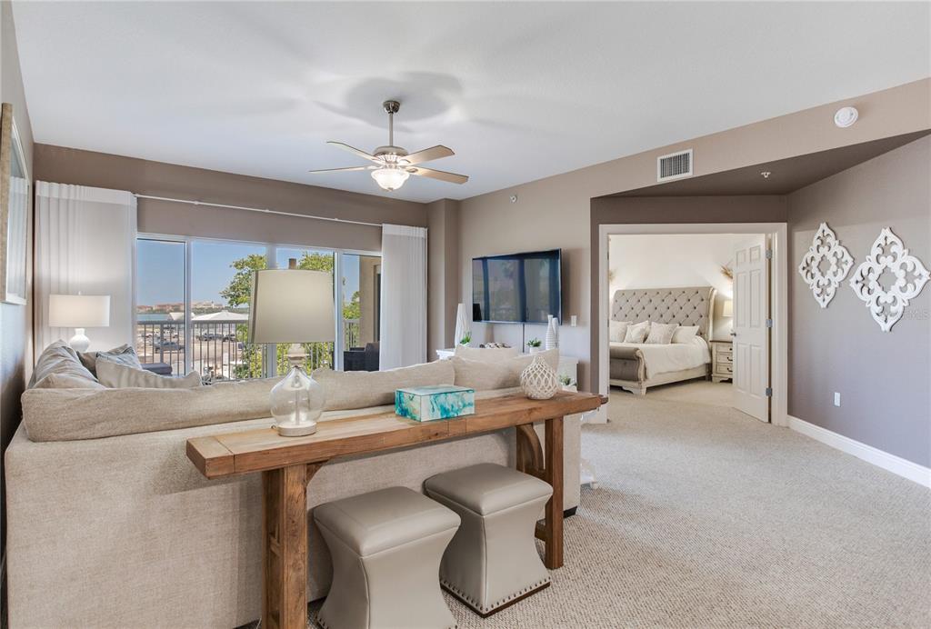 425 150th Avenue, Unit 2301 Madeira Beach, FL 33708 - Photo 12 of 67 a room with a chandelier furniture and a large window