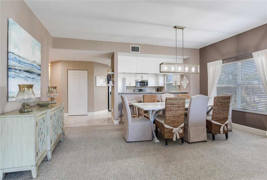 425 150th Avenue, Unit 2301 Madeira Beach, FL 33708 - Photo 19 of 67 a view of a dining room with furniture window and wooden floor