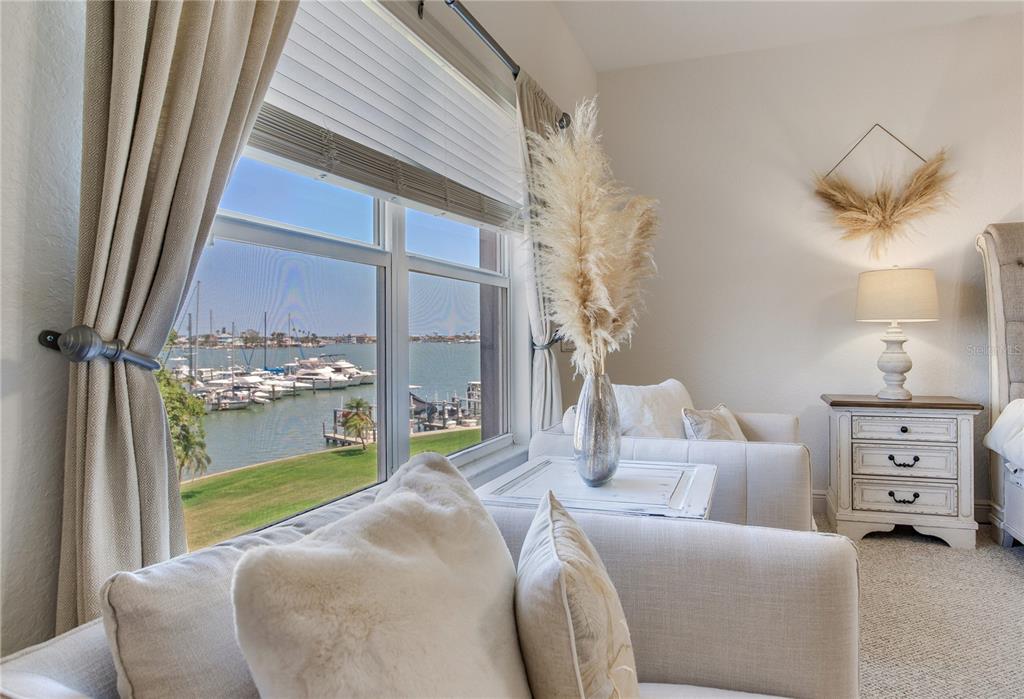 425 150th Avenue, Unit 2301 Madeira Beach, FL 33708 - Photo 30 of 67 a bedroom with a bed and a window