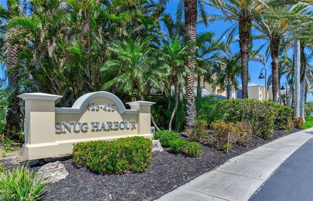 425 150th Avenue, Unit 2301 Madeira Beach, FL 33708 - Photo 54 of 67 a front view of a house with garden
