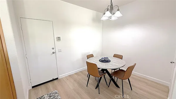 a view of a dining room with a table and chairs