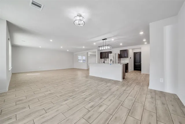 a view of an empty room and a window