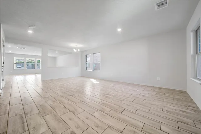 a view of empty room with wooden floor and fireplace