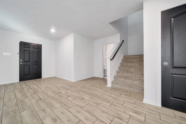 a view of an empty room with a fireplace