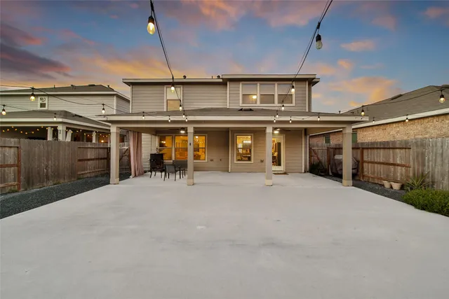 a front view of a house with a garden and yard