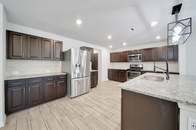 a kitchen with stainless steel appliances granite countertop a sink counter space cabinets and stainless steel appliances