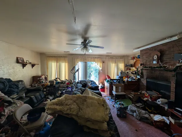 a living room filled with furniture a window and gym equipment